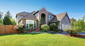 asphalt shingle roof on large family home with landscaped yard